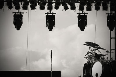 Low angle view of hanging lights against sky