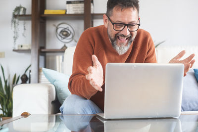 Young man using laptop at home