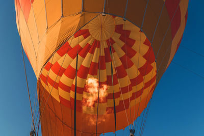 Low angle view of hot air balloon against blue sky