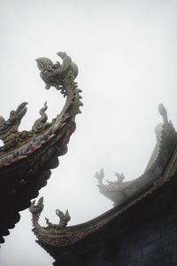 Low angle view of statue against sky