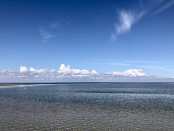 Scenic view of sea against blue sky