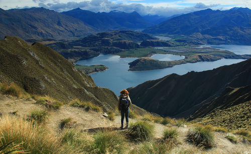 Rear view of woman standing on mountain