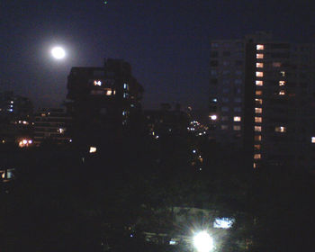 Illuminated city against sky at night