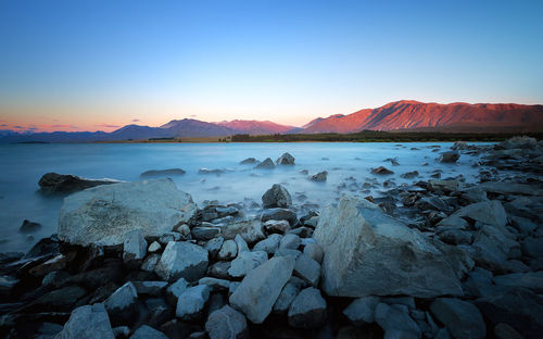 Scenic view of sea against clear sky during sunset