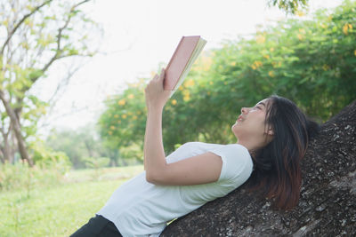 Side view of young woman looking up