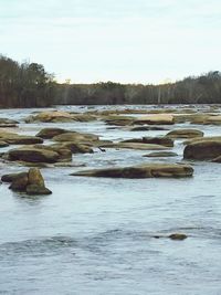 Scenic view of river against sky during winter