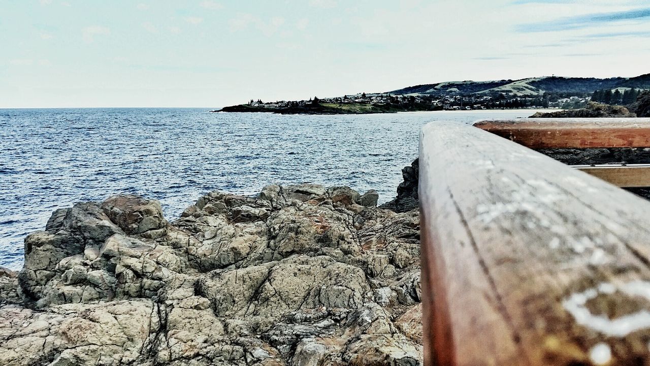 sea, water, sky, tranquility, scenics, tranquil scene, horizon over water, nature, wood - material, beauty in nature, beach, cloud - sky, day, shore, cloud, idyllic, outdoors, rock - object, pier, built structure