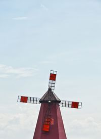 Low angle view of traditional windmill against sky