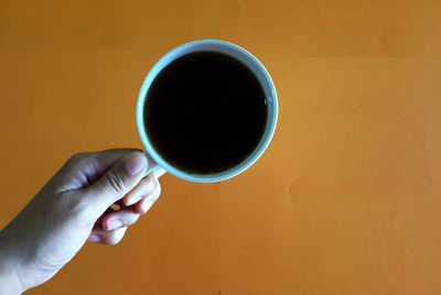 Person holding coffee cup