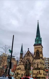 Low angle view of church against cloudy sky