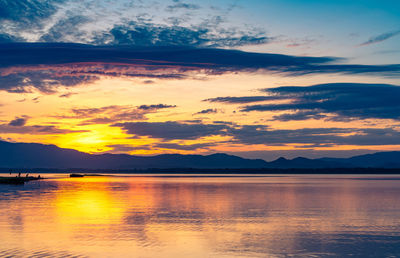 Scenic view of lake against sky during sunset