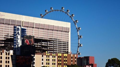 Low angle view of building against clear blue sky