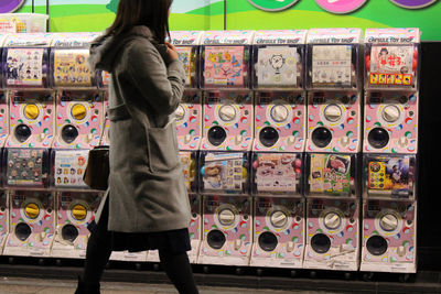 Rear view of man standing at store