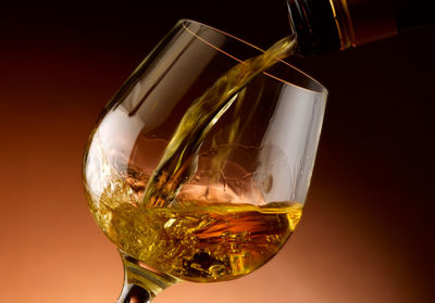 Close-up of wine glass against white background