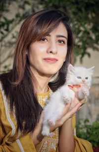 Portrait of young woman with cat