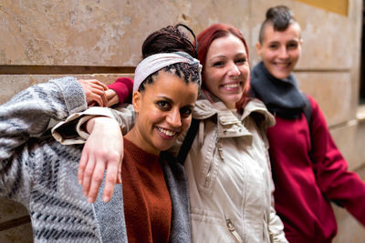 Stylish multiracial friends standing in street and looking at camera