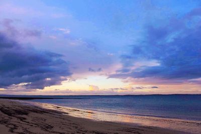 Scenic view of beach against sky during sunset