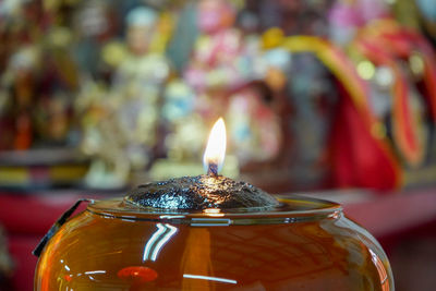 Close-up of lit tea light candles in temple