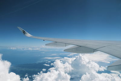 Cropped image of airplane wing against sky