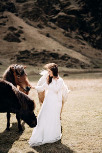 Woman with umbrella on land