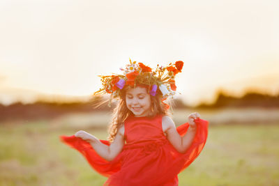 Portrait of smiling girl standing on field