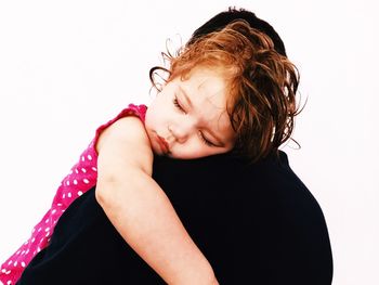 Close-up of beautiful young woman over white background