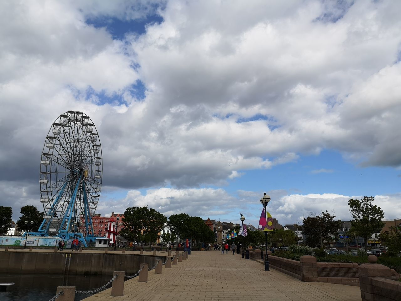 FERRIS WHEEL IN CITY AGAINST SKY