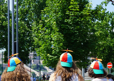 Rear view of friends wearing cap