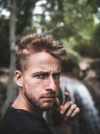 Portrait of young man standing outdoors