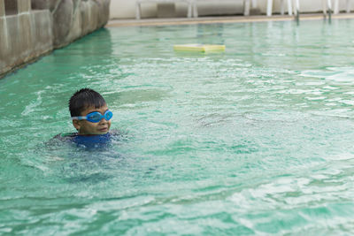 Boy swimming in pool