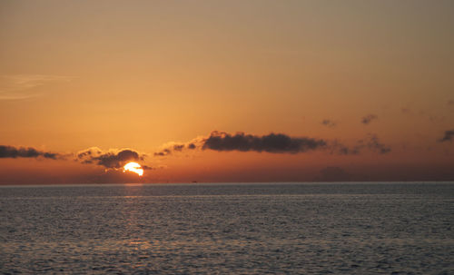 Scenic view of sea against romantic sky at sunset