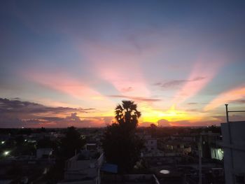 Silhouette buildings against sky during sunset