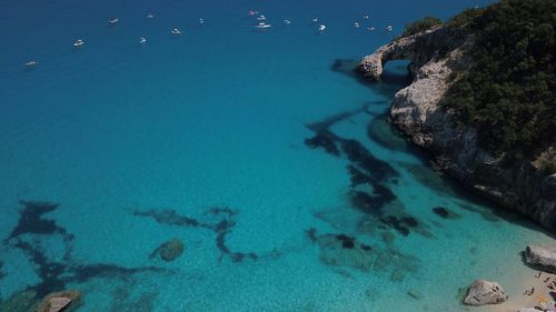 High angle view of rocks on sea shore