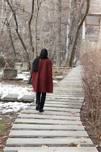 Rear view of woman standing on tree