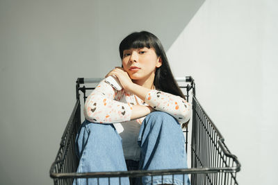 Portrait of girl sitting on railing