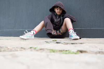 Portrait of young woman sitting outdoors