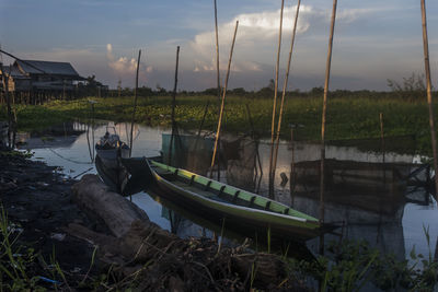 Boats moored in lake against sky