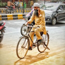 Man riding bicycle on city street