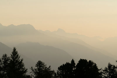 Scenic view of silhouette mountains against sky during sunset