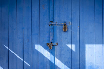 Blue wooden door with two padlocks