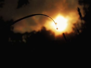 Close-up of silhouette water against sunset sky