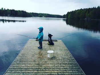 View of children fishing at lake