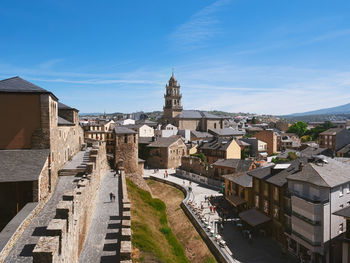 Buildings in city against clear blue sky