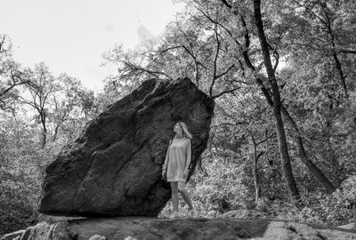 Rear view of a man standing in forest