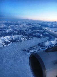 Aerial view of airplane wing over landscape