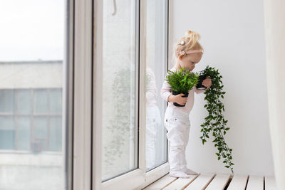 Midsection of woman standing by window