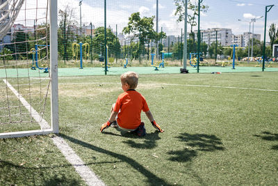 Rear view of boy playing on playground