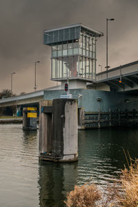 Ship on bridge in city against sky