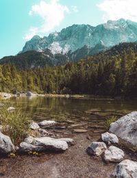 Scenic view of lake and mountains against sky