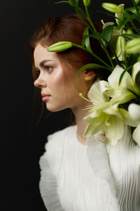 Close-up of young woman with bouquet